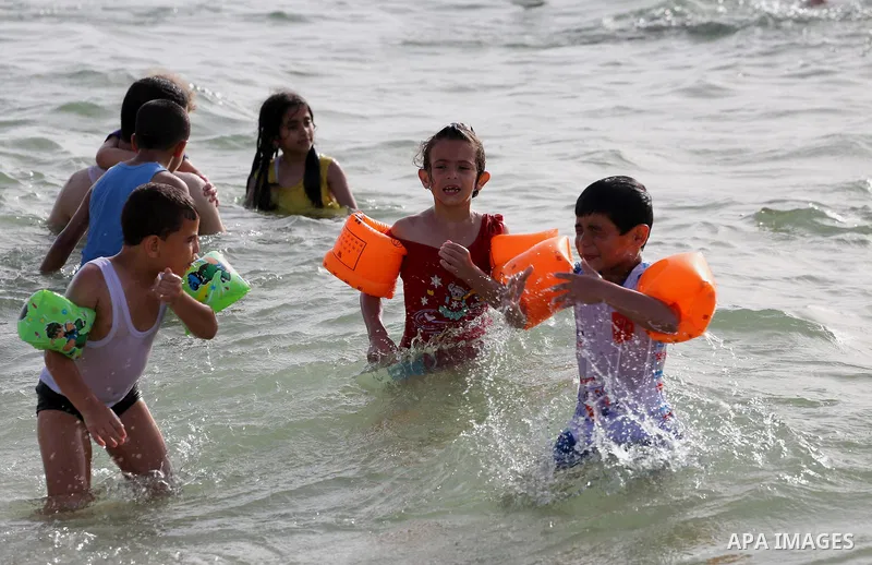 Palestininas swim in the Mediterranean sea on the coast of Gaza city, on June 03, 2016 on the last Friday before the Islamic holy month of Ramadan. Photo by Mohammed Asad