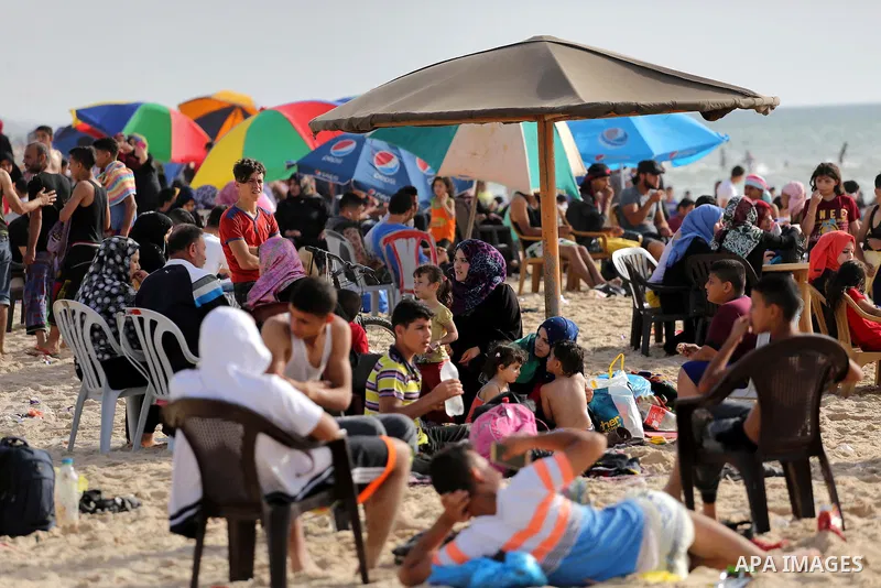 Palestinians enjoy a day at the beach of the Mediterranean sea on the coast of Gaza city, on June 03, 2016 on the last Friday before the Islamic holy month of Ramadan. Photo by Mohammed Asad