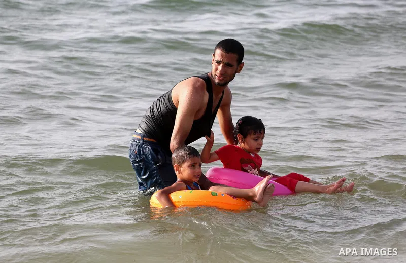 Palestininas swim in the Mediterranean sea on the coast of Gaza city, on June 03, 2016 on the last Friday before the Islamic holy month of Ramadan. Photo by Mohammed Asad