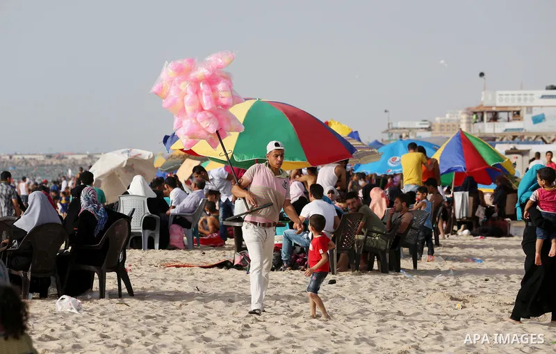 Palestinians enjoy a day at the beach of the Mediterranean sea on the coast of Gaza city, on June 03, 2016 on the last Friday before the Islamic holy month of Ramadan. Photo by Mohammed Asad