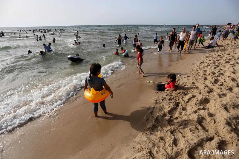 Palestininas swim in the Mediterranean sea on the coast of Gaza city, on June 03, 2016 on the last Friday before the Islamic holy month of Ramadan. Photo by Mohammed Asad