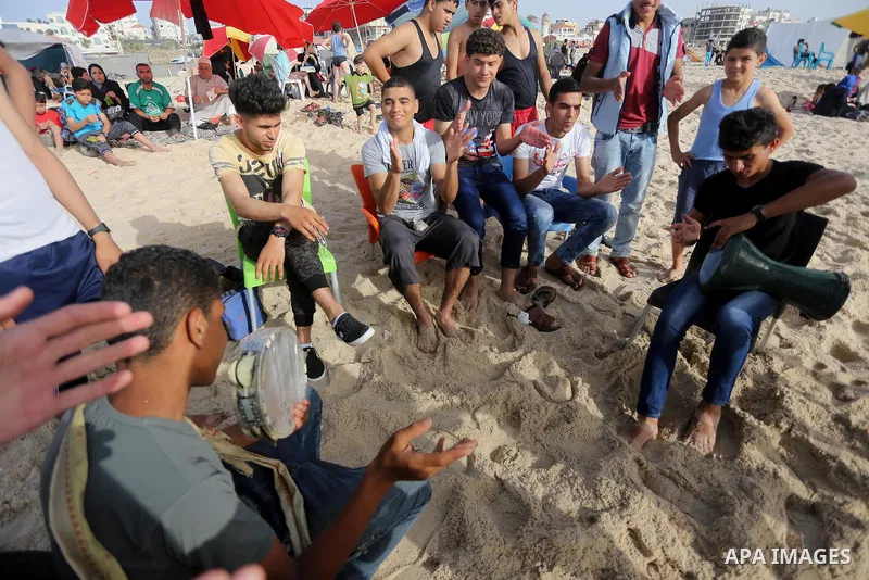 Palestinians enjoy a day at the beach of the Mediterranean sea on the coast of Gaza city, on June 03, 2016 on the last Friday before the Islamic holy month of Ramadan. Photo by Mohammed Asad