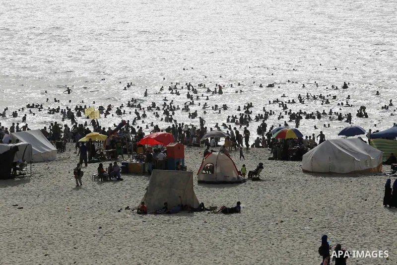 Palestininas swim in the Mediterranean sea on the coast of Gaza city, on June 03, 2016 on the last Friday before the Islamic holy month of Ramadan. Photo by Mohammed Asad