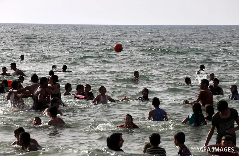 Palestininas swim in the Mediterranean sea on the coast of Gaza city, on June 03, 2016 on the last Friday before the Islamic holy month of Ramadan. Photo by Mohammed Asad