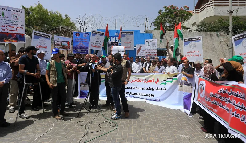 Palestinians take part in a protest to mark Naksa Day (setback), in front of the headquarter United Nation "UNSCO" in Gaza City, on June 04, 2016. Palestinians mark "Naksa Day" to mourn the 49th anniversary of Israel's o...