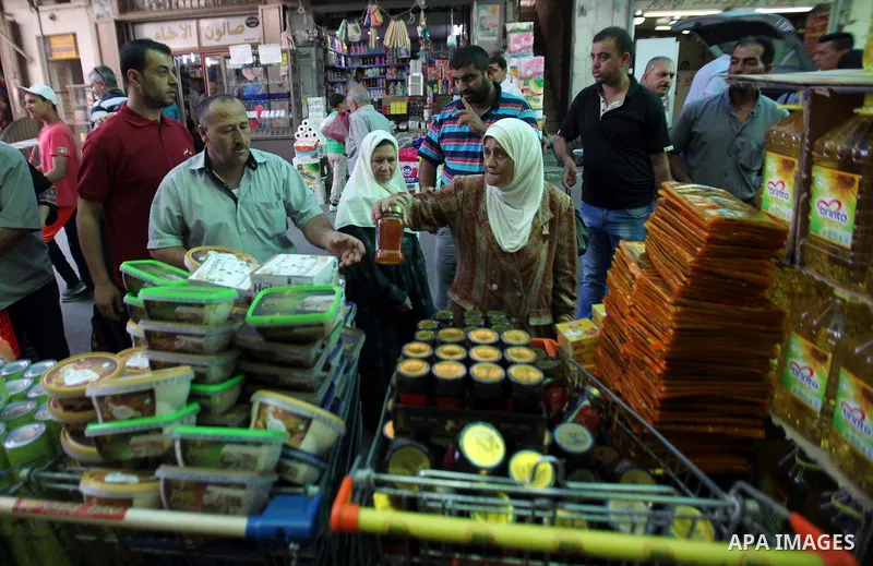 Palestinians shop at a traditional market in preparation for the holy month of Ramadan in the west bank city of Nablus on June 4,2016. Muslims around the world refrain from eating, drinking and sexual intercourse from da...