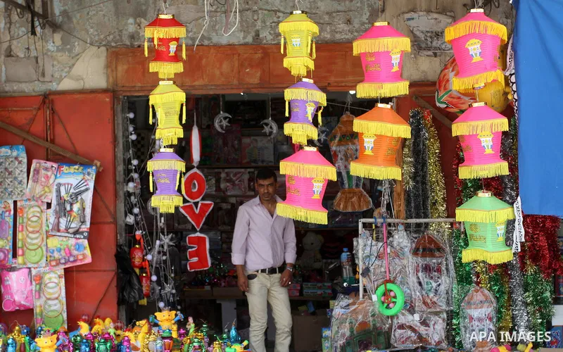 A Palestinian vendor displays a traditional lantern known in Arabic as "Fanous" and toys at a traditional market in preparation for the holy month of Ramadan in Rafah in the southern Gaza strip on June 4,2016. Muslims ar...