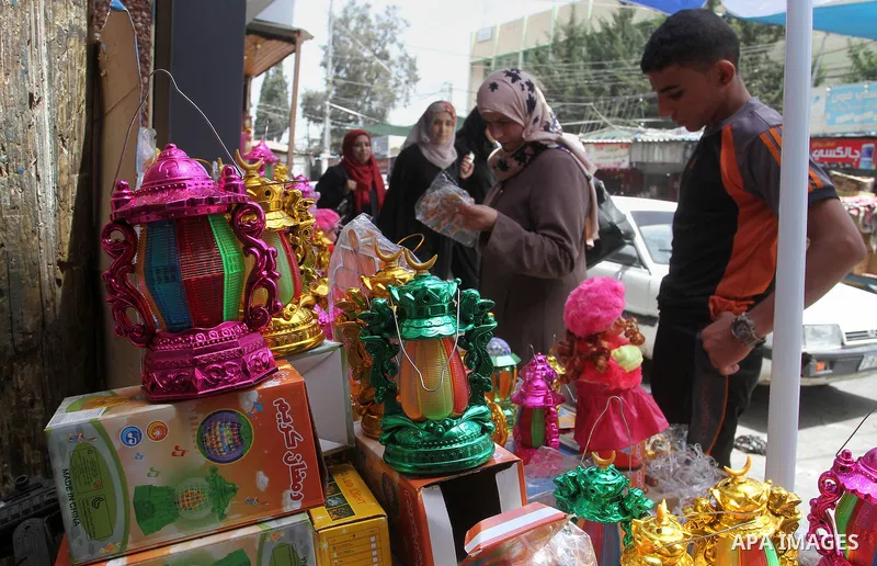 A Palestinian vendor displays a traditional lantern known in Arabic as "Fanous" and toys at a traditional market in preparation for the holy month of Ramadan in Rafah in the southern Gaza strip on June 4,2016. Muslims ar...