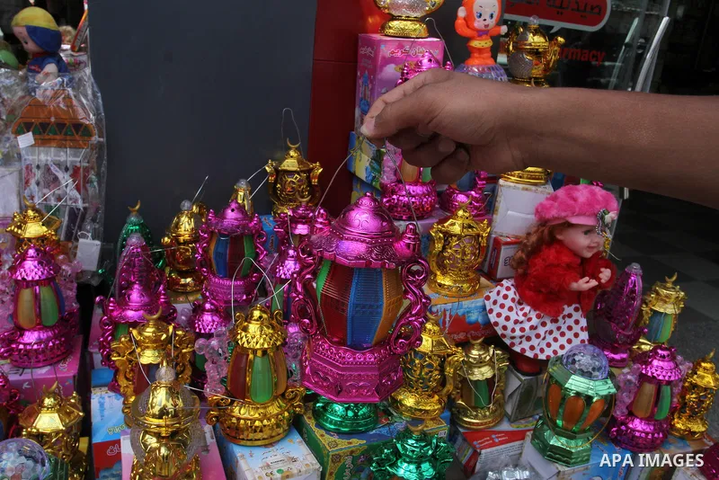 A Palestinian vendor displays a traditional lantern known in Arabic as "Fanous" and toys at a traditional market in preparation for the holy month of Ramadan in Rafah in the southern Gaza strip on June 4,2016. Muslims ar...