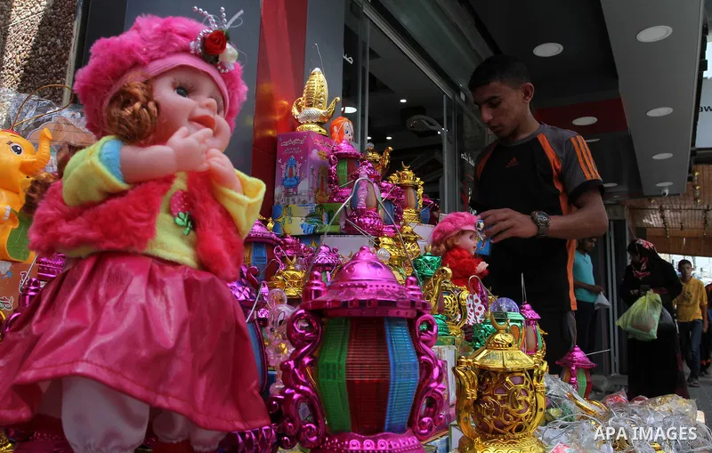 A Palestinian vendor displays a traditional lantern known in Arabic as "Fanous" and toys at a traditional market in preparation for the holy month of Ramadan in Rafah in the southern Gaza strip on June 4,2016. Muslims ar...
