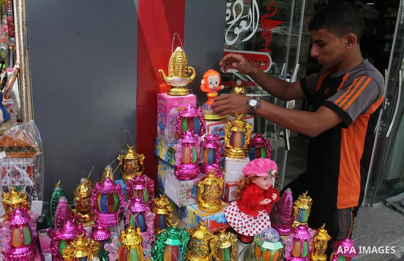 A Palestinian vendor displays a traditional lantern known in Arabic as "Fanous" and toys at a traditional market in preparation for the holy month of Ramadan in Rafah in the southern Gaza strip on June 4,2016. Muslims ar...