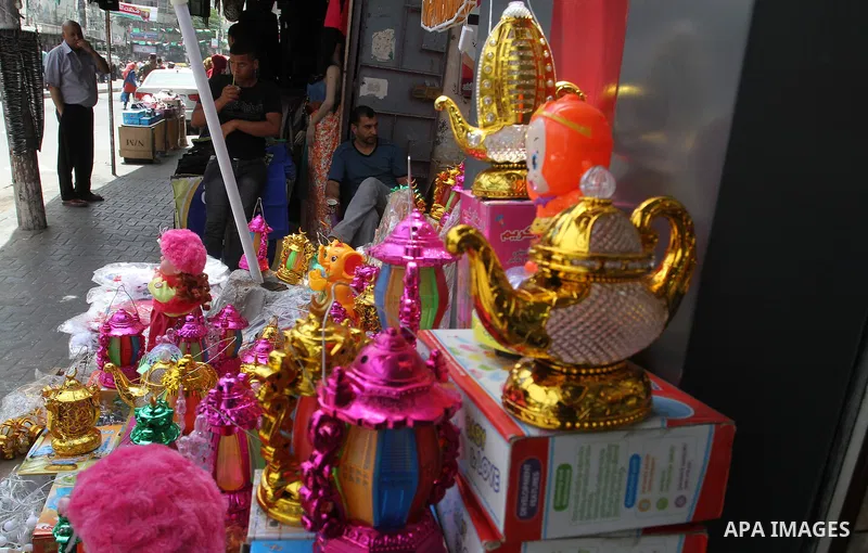 A Palestinian vendor displays a traditional lantern known in Arabic as "Fanous" and toys at a traditional market in preparation for the holy month of Ramadan in Rafah in the southern Gaza strip on June 4,2016. Muslims ar...