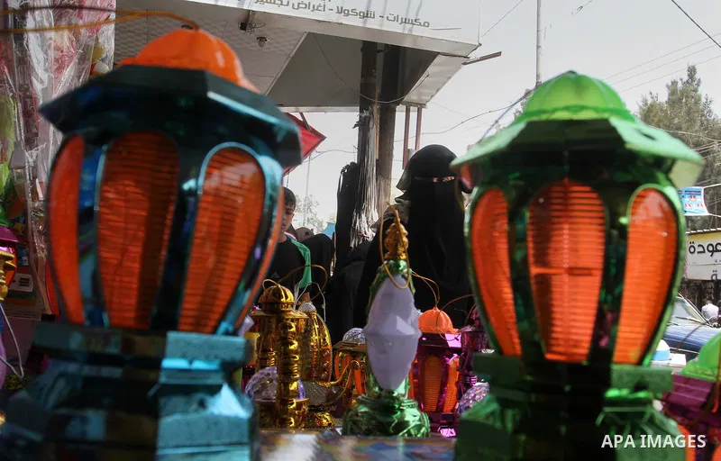 A Palestinian vendor displays a traditional lantern known in Arabic as "Fanous" and toys at a traditional market in preparation for the holy month of Ramadan in Rafah in the southern Gaza strip on June 4,2016. Muslims ar...