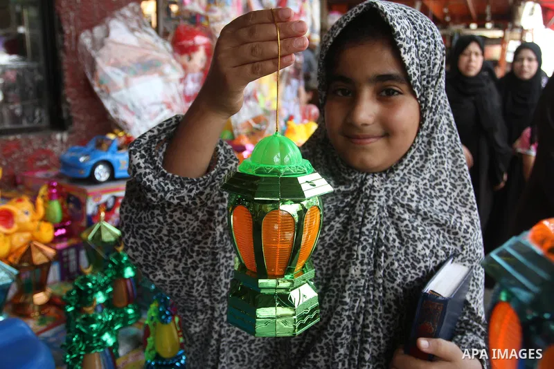 A Palestinian vendor displays a traditional lantern known in Arabic as "Fanous" and toys at a traditional market in preparation for the holy month of Ramadan in Rafah in the southern Gaza strip on June 4,2016. Muslims ar...