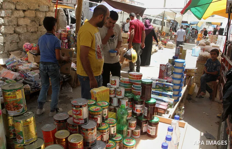 Palestinians shop at a traditional market in preparation for the holy month of Ramadan in Rafah in the southern Gaza strip on June 4,2016. Muslims around the world refrain from eating, drinking and sexual intercourse fro...