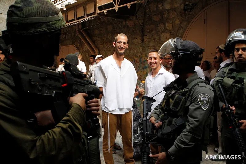 Israeli troops guard Israeli settlers during their weekly tour through the Old City of West Bank city of Hebron, 04 June 2016. Every Saturday a tour through Hebron's Old City, which is usually off limits for Israeli sett...