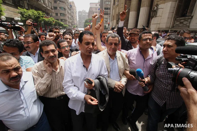 Yahia Kalash, the head of the journalists' union, is surrounded by cameramen as he arrives at Cairo south court in Cairo, Egypt, Saturday, June 4, 2016. The head of Egypt's journalists union and two of its board members...