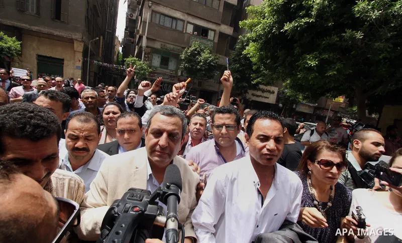 Yahia Kalash, the head of the journalists' union, is surrounded by cameramen as he arrives at Cairo south court in Cairo, Egypt, Saturday, June 4, 2016. The head of Egypt's journalists union and two of its board members...