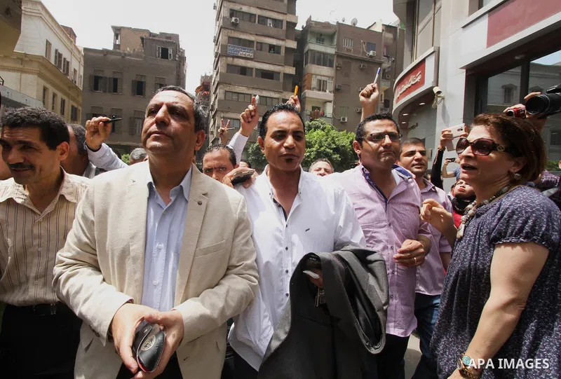 Yahia Kalash, the head of the journalists' union, is surrounded by cameramen as he arrives at Cairo south court in Cairo, Egypt, Saturday, June 4, 2016. The head of Egypt's journalists union and two of its board members...
