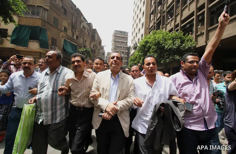 Yahia Kalash, the head of the journalists' union, is surrounded by cameramen as he arrives at Cairo south court in Cairo, Egypt, Saturday, June 4, 2016. The head of Egypt's journalists union and two of its board members...