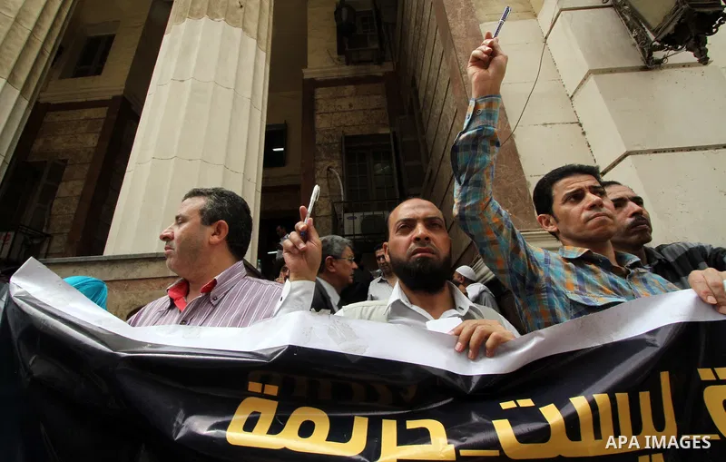 Egyptian Journalists and activists chant slogans and hold banners during a protest in front of the Journalists' Syndicate in Cairo, Egypt, on June 4, 2016. Photo by Amr Sayed