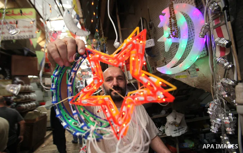 A Palestinian vendor displays traditional lanterns known in Arabic as "Fanous" sold during the Muslim holy month of Ramadan at a market in the west bank city of Nablus , on June 5, 2016 as the faithful prepare to start f...