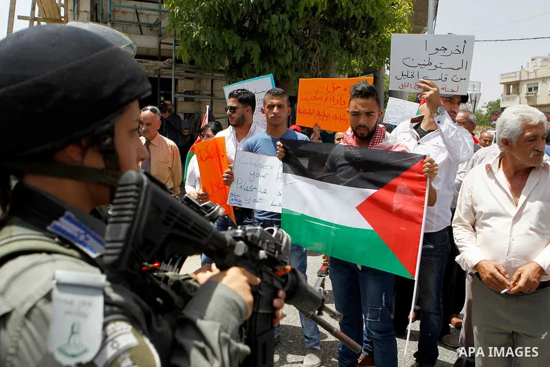Palestinians take part in a demonstration to mark Naksa Day (setback), in the West Bank city of Hebron, on June 04, 2016. Palestinians mark "Naksa Day" to mourn the 49th anniversary of Israel's occupation of the West Ban...