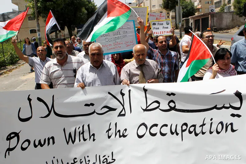 Palestinians take part in a demonstration to mark Naksa Day (setback), in the West Bank city of Hebron, on June 04, 2016. Palestinians mark "Naksa Day" to mourn the 49th anniversary of Israel's occupation of the West Ban...