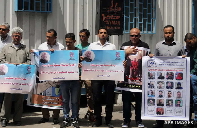 Palestinian journalists take part in a protest demanding release the journalists prisoners in Israeli jails, in front of the high commissioner for human rights headquarters in Gaza City, on June 5, 2016. Photo by Mohamme...