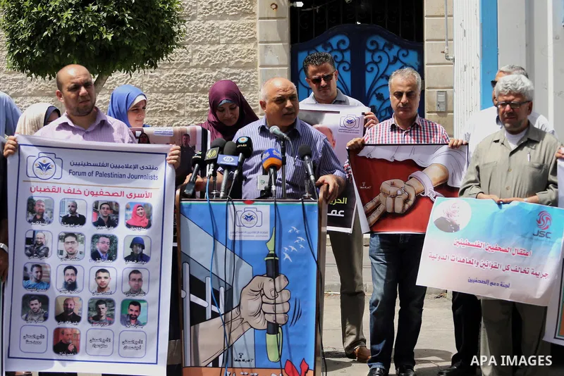 Palestinian journalists take part in a protest demanding release the journalists prisoners in Israeli jails, in front of the high commissioner for human rights headquarters in Gaza City, on June 5, 2016. Photo by Mohamme...