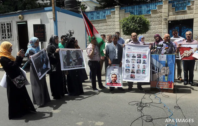 Palestinian journalists take part in a protest demanding release the journalists prisoners in Israeli jails, in front of the high commissioner for human rights headquarters in Gaza City, on June 5, 2016. Photo by Mohamme...
