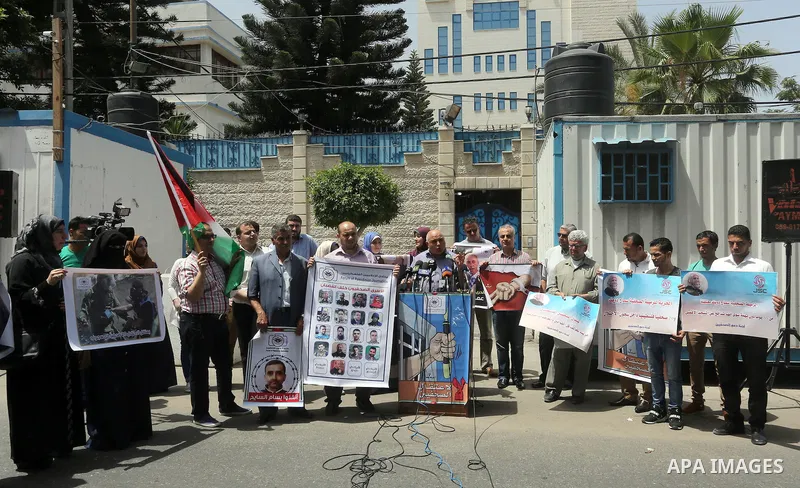 Palestinian journalists take part in a protest demanding release the journalists prisoners in Israeli jails, in front of the high commissioner for human rights headquarters in Gaza City, on June 5, 2016. Photo by Mohamme...