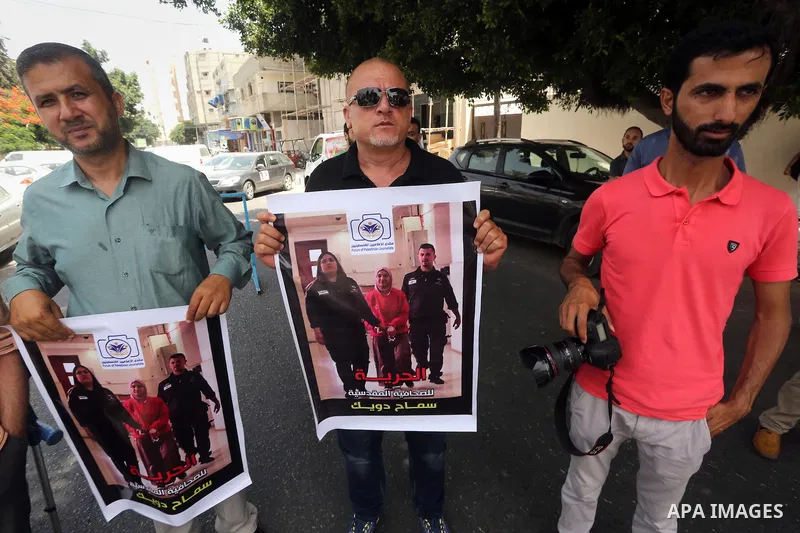 Palestinian journalists take part in a protest demanding release the journalists prisoners in Israeli jails, in front of the high commissioner for human rights headquarters in Gaza City, on June 5, 2016. Photo by Mohamme...