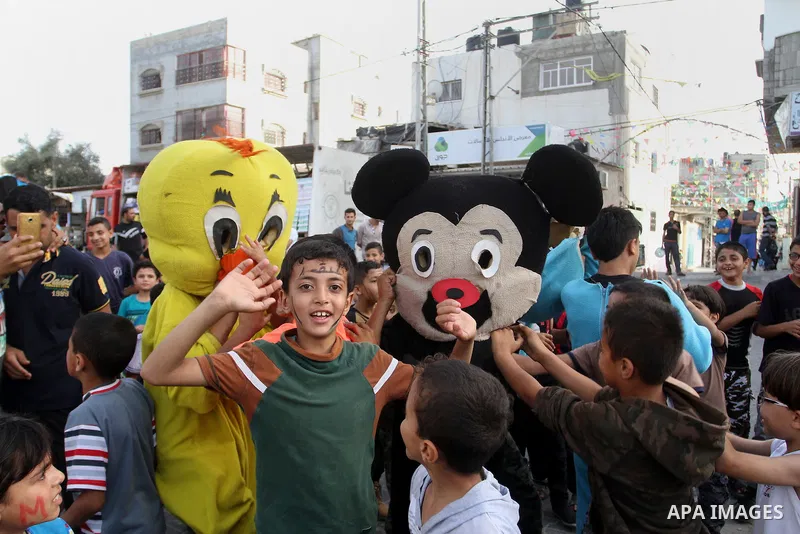 Palestinian children take part in a street celebration ahead of the beginning of the Muslim holy month of Ramadan in Rafah in the southern Gaza strip on June 5, 2016. More than 1.5 billion Muslims around the world will s...