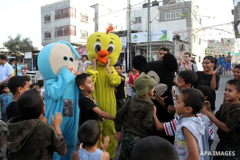 Palestinian children take part in a street celebration ahead of the beginning of the Muslim holy month of Ramadan in Rafah in the southern Gaza strip on June 5, 2016. More than 1.5 billion Muslims around the world will s...