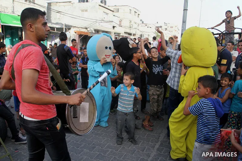 Palestinian children take part in a street celebration ahead of the beginning of the Muslim holy month of Ramadan in Rafah in the southern Gaza strip on June 5, 2016. More than 1.5 billion Muslims around the world will s...