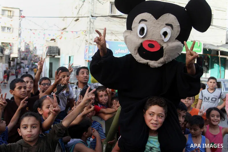 Palestinian children take part in a street celebration ahead of the beginning of the Muslim holy month of Ramadan in Rafah in the southern Gaza strip on June 5, 2016. More than 1.5 billion Muslims around the world will s...
