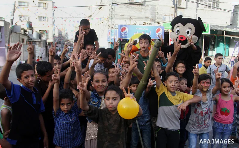 Palestinian children take part in a street celebration ahead of the beginning of the Muslim holy month of Ramadan in Rafah in the southern Gaza strip on June 5, 2016. More than 1.5 billion Muslims around the world will s...