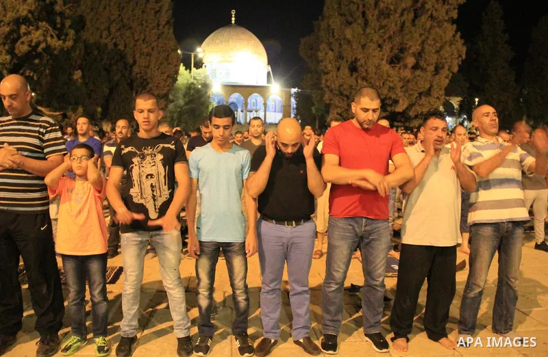 Palestinian Muslim worshipers perform 'taraweeh', nightly prayer of the month of Ramadan, outside the al-Aqsa mosque, in Jerusalem's old city on June 05, 2016. More than 1.5 billion Muslims around the world will start to...