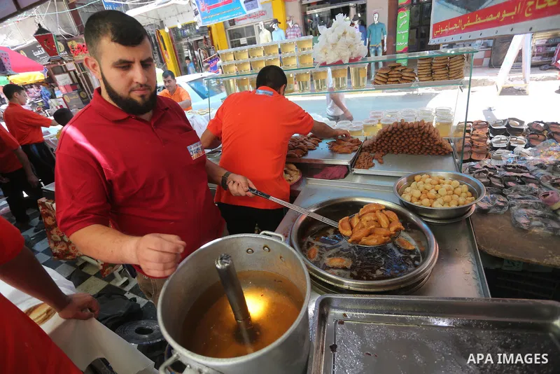 A Palestinian man prepares traditional pancakes known as ''Qatayef at a market on the first day of the Ramadan, in Gaza city, on June 6, 2016 as the faithful prepare to start fasting. More than 1.5 billion Muslims around...