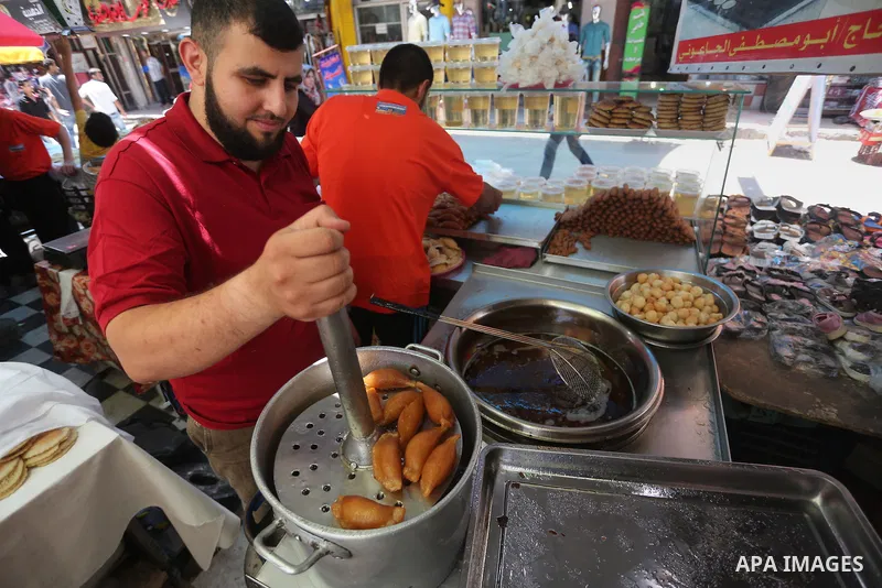 A Palestinian man prepares traditional pancakes known as ''Qatayef at a market on the first day of the Ramadan, in Gaza city, on June 6, 2016 as the faithful prepare to start fasting. More than 1.5 billion Muslims around...