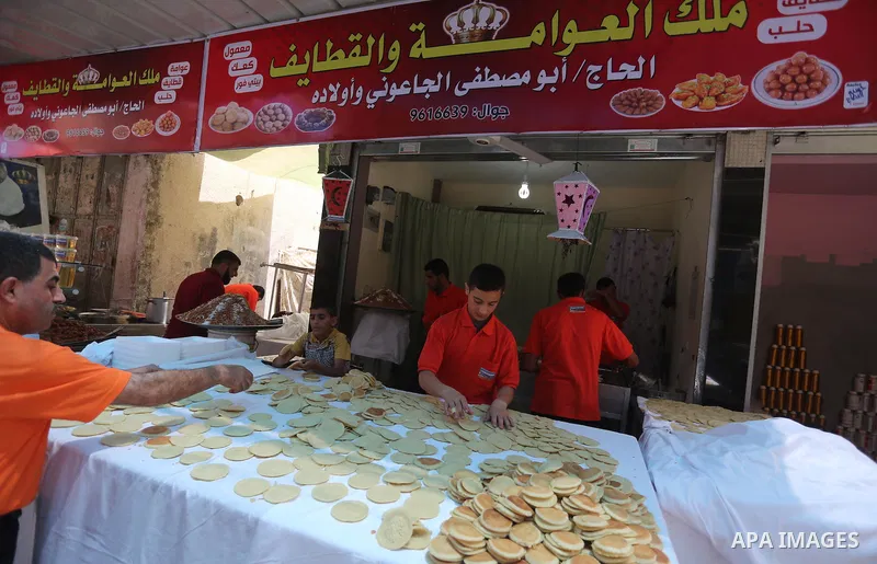 A Palestinian man prepares traditional pancakes known as ''Qatayef at a market on the first day of the Ramadan, in Gaza city, on June 6, 2016 as the faithful prepare to start fasting. More than 1.5 billion Muslims around...