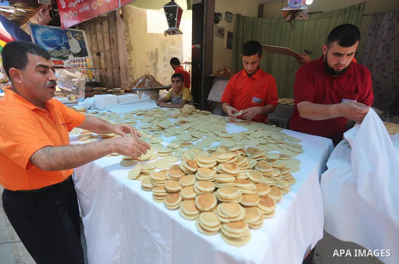 A Palestinian man prepares traditional pancakes known as ''Qatayef at a market on the first day of the Ramadan, in Gaza city, on June 6, 2016 as the faithful prepare to start fasting. More than 1.5 billion Muslims around...