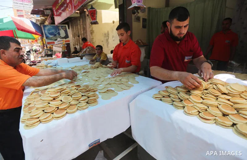 A Palestinian man prepares traditional pancakes known as ''Qatayef at a market on the first day of the Ramadan, in Gaza city, on June 6, 2016 as the faithful prepare to start fasting. More than 1.5 billion Muslims around...