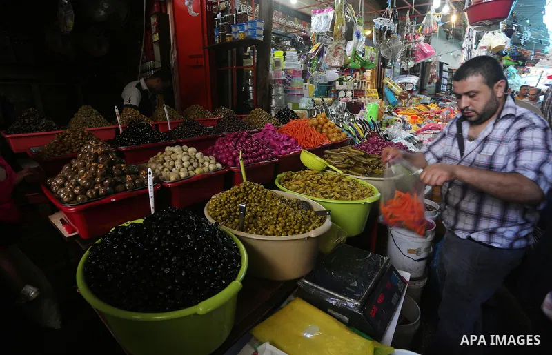 A Palestinian man sells pickles in her shop at a market on the first day of the Ramadan, in Gaza city, on June 6, 2016 as the faithful prepare to start fasting. More than 1.5 billion Muslims around the world will start t...
