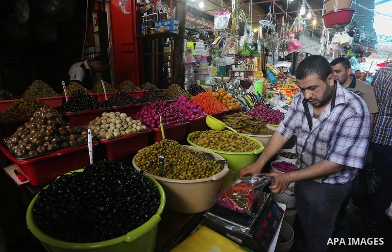 A Palestinian man sells pickles in her shop at a market on the first day of the Ramadan, in Gaza city, on June 6, 2016 as the faithful prepare to start fasting. More than 1.5 billion Muslims around the world will start t...