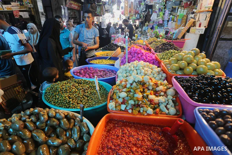 A Palestinian man sells pickles in her shop at a market on the first day of the Ramadan, in Gaza city, on June 6, 2016 as the faithful prepare to start fasting. More than 1.5 billion Muslims around the world will start t...