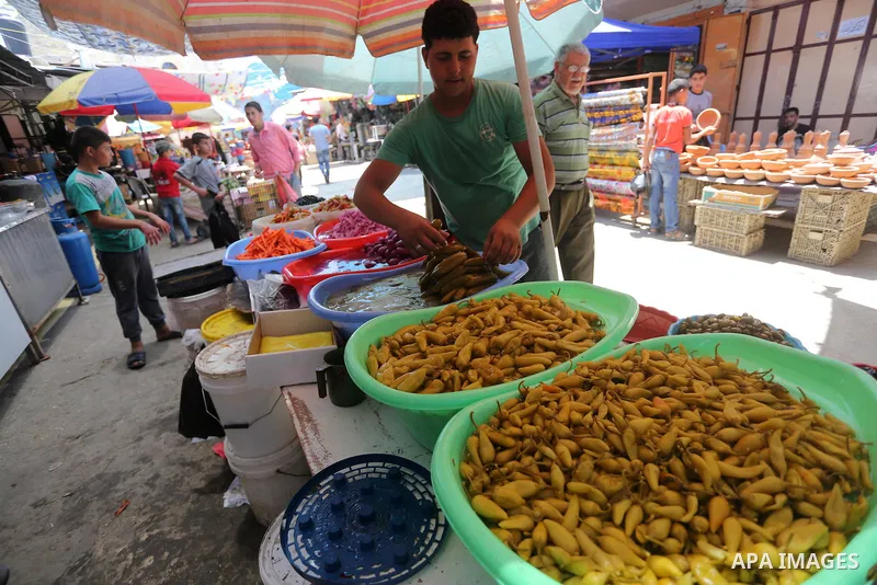 A Palestinian man sells pickles in her shop at a market on the first day of the Ramadan, in Gaza city, on June 6, 2016 as the faithful prepare to start fasting. More than 1.5 billion Muslims around the world will start t...