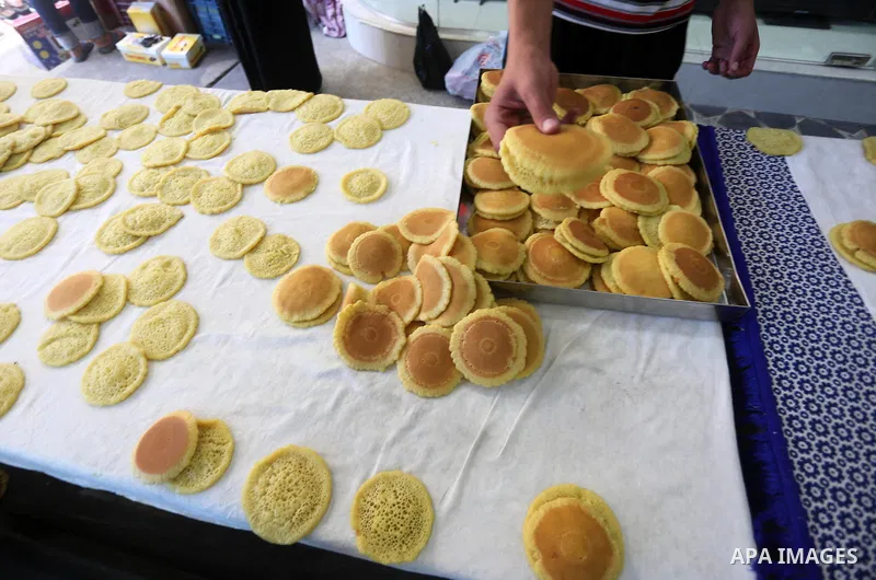 A Palestinian man prepares traditional pancakes known as ''Qatayef at a market on the first day of the Ramadan, in Gaza city, on June 6, 2016 as the faithful prepare to start fasting. More than 1.5 billion Muslims around...