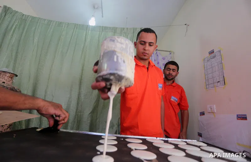 A Palestinian man prepares traditional pancakes known as ''Qatayef at a market on the first day of the Ramadan, in Gaza city, on June 6, 2016 as the faithful prepare to start fasting. More than 1.5 billion Muslims around...